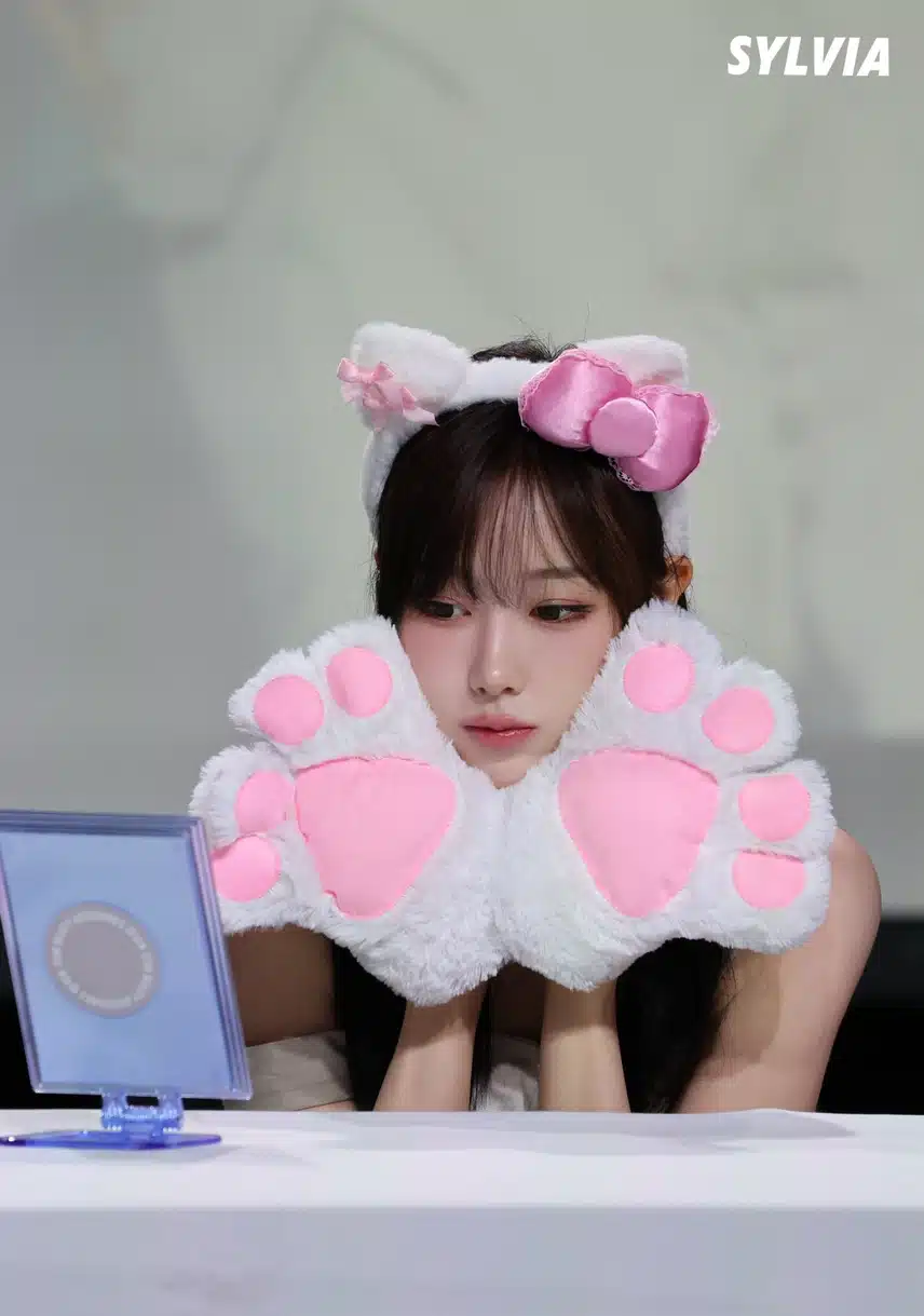 Giselle turned into a cat with a cat headband and gloves